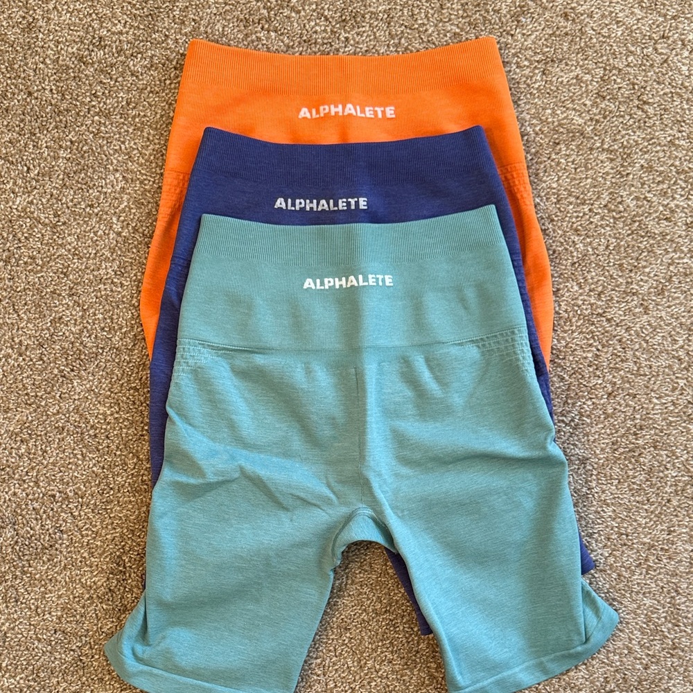 Alphalete Seamless Shorts - Orange, Blue, and Purple.